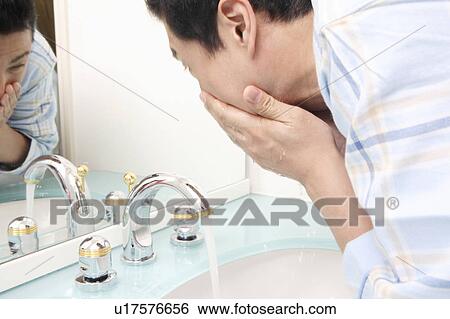 Stock Photograph - Man washing a face. Fotosearch