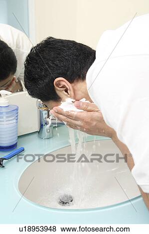 Stock Photo - Man washing his face. Fotosearch