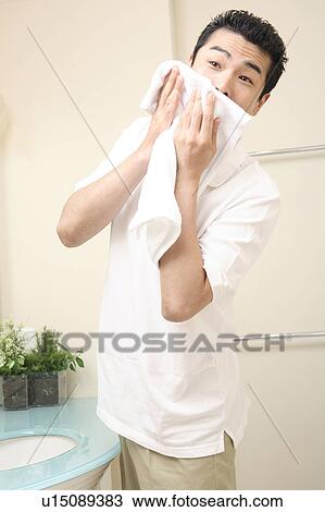 Man wiping his face View Large Photo Image Stock Image - Man wiping his face. Fotosearch
