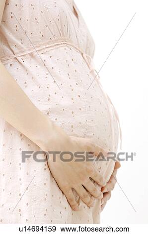 Stock Photo - Stomach of the pregnant woman. Fotosearch