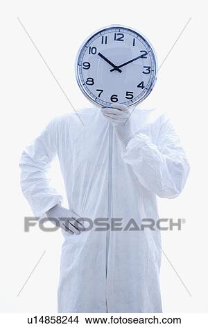 Biohazard suit holding clock in front of face View Large Photo Image Picture - Biohazard suit holding clock in front of face. Fotosearch