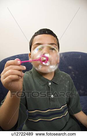 Stock Photo - Blowing large soap bubble. Fotosearch