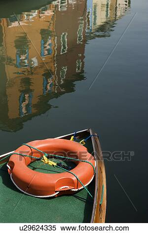 Boat with reflection of buildings in water in background View Large Photo Image Stock Photography - Boat with reflection of buildings in water in background. Fotosearch