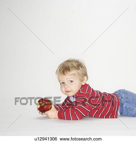 Boy holding apple View Large Photo Image Stock Photograph - Boy holding apple . Fotosearch
