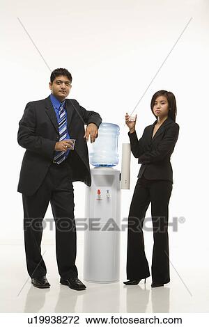 Business people standing at water cooler View Large Photo Image Stock Image - Business people standing at water cooler . Fotosearch