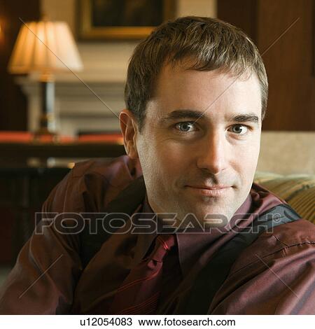 Stock Image - Businessman smiling at viewer. Fotosearch
