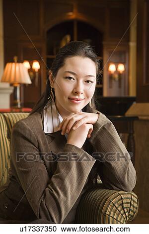 Businesswoman with chin resting on hands View Large Photo Image Stock Image - Businesswoman with chin resting on hands. Fotosearch