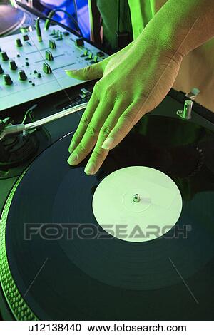 Close-up DJ's hand spinning vinyl record View Large Photo Image Stock Image - Close-up DJ's hand spinning vinyl record. Fotosearch