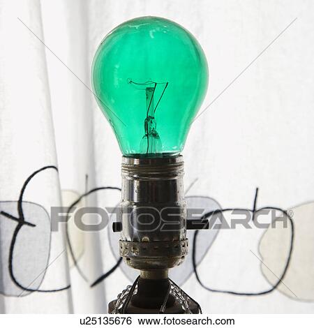 Close up of green light bulb in lamp View Large Photo Image Stock Photograph - Close up of green light bulb in lamp. Fotosearch