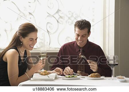 Stock Photograph - Couple dining in restaurant. Fotosearch