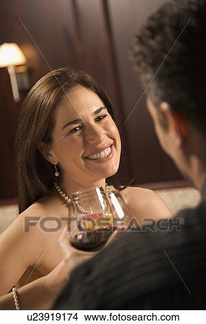 Picture - Couple holding wine glasses . Fotosearch