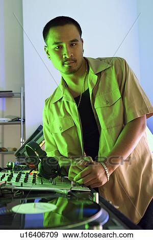 Stock Photo - DJ leaning on turntable. Fotosearch