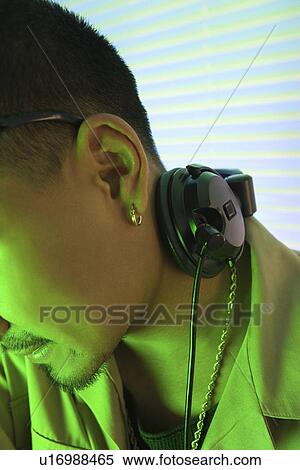 Stock Photography - DJ's ear and profile with headphones. Fotosearch