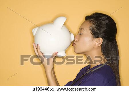 Doctor kissing piggy bank View Large Photo Image Stock Photography - Doctor kissing piggy bank . Fotosearch