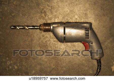 Electric drill resting on cement floor View Large Photo Image Stock Photo - Electric drill resting on cement floor. Fotosearch