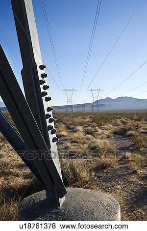 Stock Photo - Electrical power lines in barren desert landscape. Fotosearch