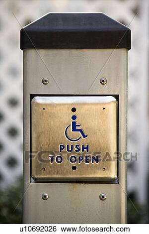 Stock Photograph - Entrance button for physically challenged people. Fotosearch
