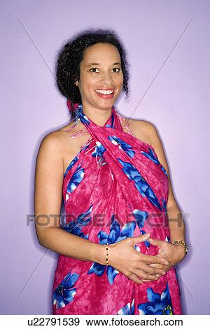 Stock Photo - Expecting female with hands on stomach. Fotosearch