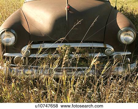 Front end of old abandoned antique car in field. View Large Photo Image Stock Photo - Front end of old abandoned antique car in field.. Fotosearch