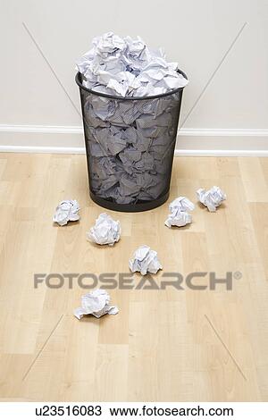 Full wire mesh trash can with crumpled paper scattered around View Large Photo Image Stock Image - Full wire mesh trash can with crumpled paper scattered around. Fotosearch