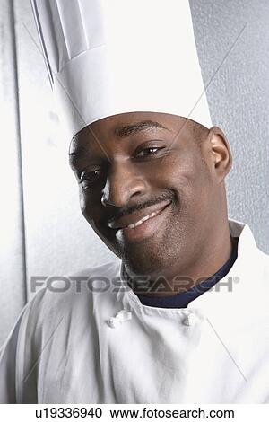 Head shot of chef wearing traditional uniform and toque looking at viewer smiling View Large Photo Image Stock Image - Head shot of chef wearing traditional uniform and toque looking at viewer smiling. Fotosearch