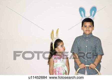 Picture - Kids wearing bunny ears. Fotosearch