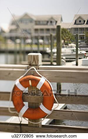 Stock Photography - Life preserver hanging on dock on Bald Head Island, North Carolina.. Fotosearch