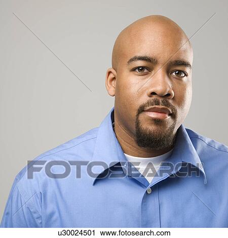 Stock Image - Man against gray background. Fotosearch