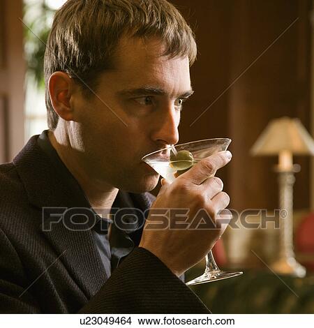 Man drinking martini View Large Photo Image Picture - Man drinking martini. Fotosearch
