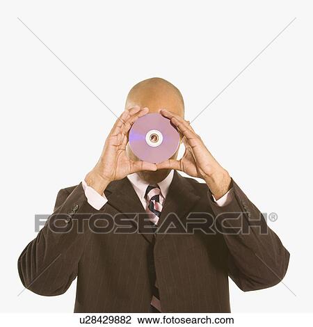 Man holding compact disc over his face View Large Photo Image Stock Image - Man holding compact disc over his face. Fotosearch