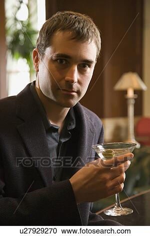 Man holding martini View Large Photo Image Stock Image - Man holding martini . Fotosearch