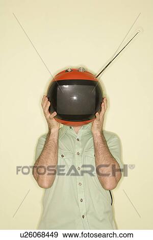 Stock Photo - Man holding round red retro television in place of head. Fotosearch
