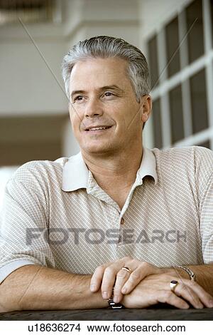 Man sitting at table View Large Photo Image Picture - Man sitting at table. Fotosearch