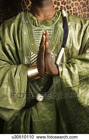 Man wearing traditional African clothing View Large Photo Image Stock Image - Man wearing traditional African clothing. Fotosearch