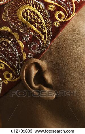 Stock Image - Man wearing traditional African hat. Fotosearch