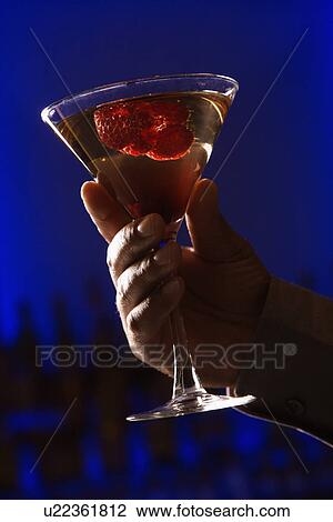 Martini with raspberry fruit against glowing blue background View Large Photo Image Stock Image - Martini with raspberry fruit against glowing blue background. Fotosearch