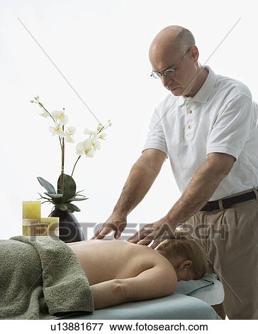 Massage therapist massaging back of woman View Large Photo Image Stock Photo - Massage therapist massaging back of woman . Fotosearch