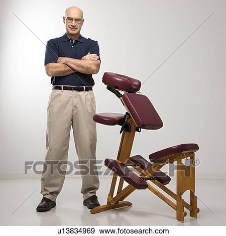 Massage therapist with massage chair View Large Photo Image Stock Photo - Massage therapist with massage chair. Fotosearch