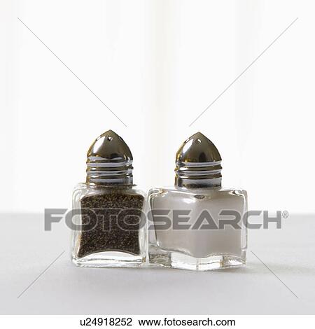Stock Image - Matching salt and pepper shakers on white. Fotosearch