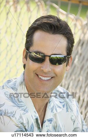 Mid adult man wearing sunglasses. View Large Photo Image Stock Image - Mid adult man wearing sunglasses.. Fotosearch