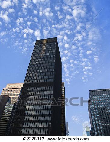 New York City skyscrapers with blue sky in background View Large Photo Image Stock Photo - New York City skyscrapers with blue sky in background. Fotosearch