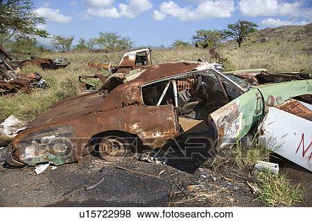 Stock Photo - Old rusted car in junkyard. Fotosearch