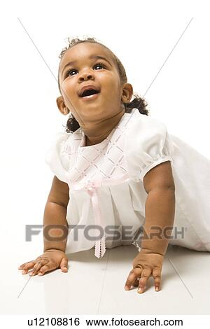 Portrait of infant girl against white background View Large Photo Image Stock Photograph - Portrait of infant girl against white background. Fotosearch