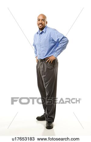 Portrait of man standing against white background View Large Photo Image Stock Image - Portrait of man standing against white background. Fotosearch