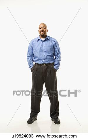 Portrait of man standing against white background View Large Photo Image Stock Image - Portrait of man standing against white background. Fotosearch