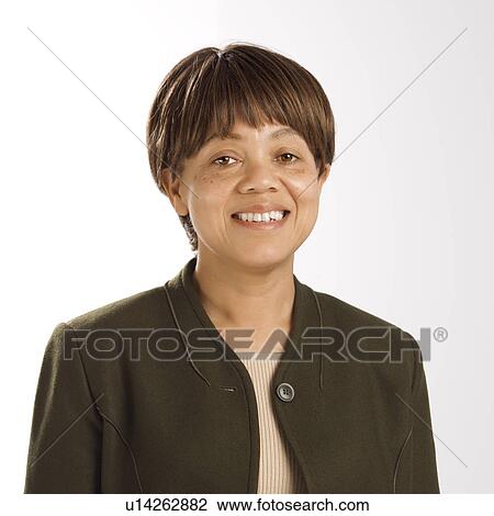 Stock Image - Portrait of middle-aged woman smiling and looking at viewer. Fotosearch