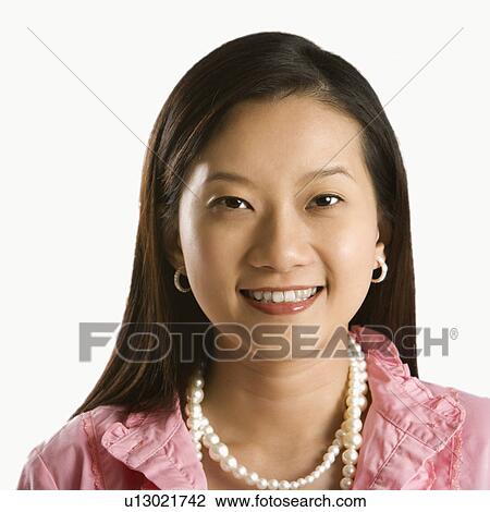Stock Image - Portrait of young adult woman smiling and looking at viewer. Fotosearch