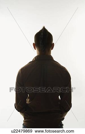 Stock Photo - Rear view of Caucasian man with mohawk standing against white background.. Fotosearch