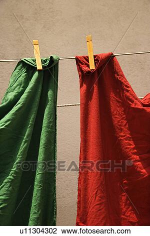 Stock Image - Red and green fabric hanging on clothesline in Lisbon, Portugal. Fotosearch