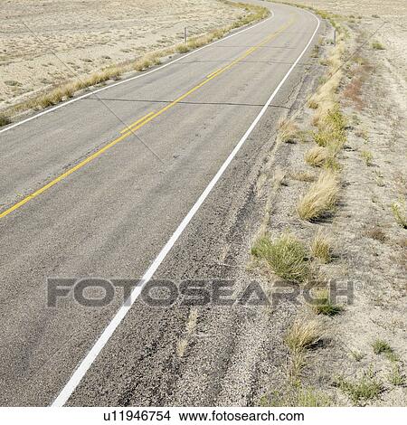 Picture - Road through barren landscape in Utah. Fotosearch